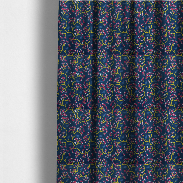 The fabric used to create these made-to-measure curtains is a deep blue fabric pattern featuring a winding trail of bright yellow vines accented with clusters of pink and white flowers and blue fern leaves.