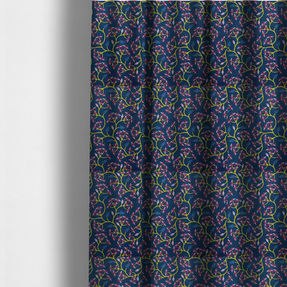 The fabric used to create these made-to-measure curtains is a deep blue fabric pattern featuring a winding trail of bright yellow vines accented with clusters of pink and white flowers and blue fern leaves.