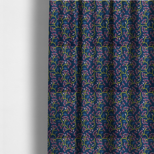 The fabric used to create these made-to-measure curtains is a deep blue fabric pattern featuring a winding trail of bright yellow vines accented with clusters of pink and white flowers and blue fern leaves.
