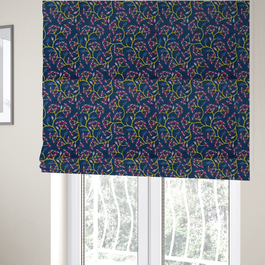 The fabric used to create these Roman blinds is a deep blue fabric pattern featuring a winding trail of bright yellow vines accented with clusters of pink and white flowers and blue fern leaves.