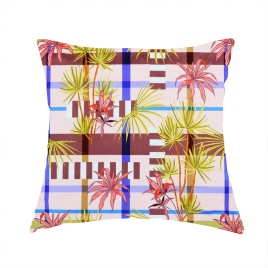 The fabric used to create this handmade cushion is a eclectic, geometric tropical fabric pattern featuring a unique overlay design. The background is a structured windowpane plaid layout composed of intersecting lines in cobalt blue, olive green, and chocolate brown across a dusty pink base. Layered over this grid is a repeating botanical print of tropical plants, featuring fan palms in lime green and slender fronds in terracotta pink.