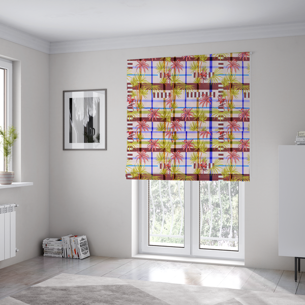 The fabric used to create these Roman blinds is a eclectic, geometric tropical fabric pattern featuring a unique overlay design. The background is a structured windowpane plaid layout composed of intersecting lines in cobalt blue, olive green, and chocolate brown across a dusty pink base. Layered over this grid is a repeating botanical print of tropical plants, featuring fan palms in lime green and slender fronds in terracotta pink.