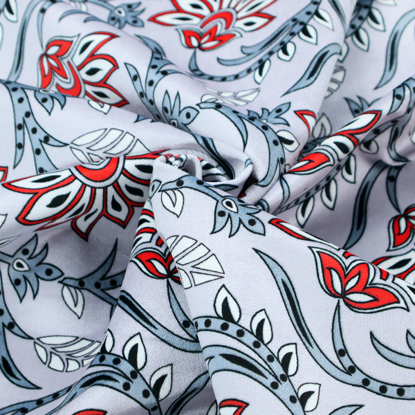 An ornate, traditional Kalamkari-style pattern of swirling grey vines and large lotus-like flowers with red and white petals on a light grey background.