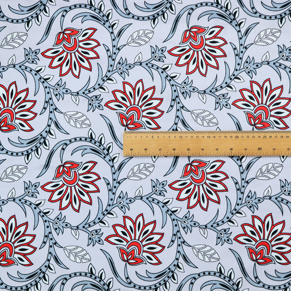 An ornate, traditional Kalamkari-style pattern of swirling grey vines and large lotus-like flowers with red and white petals on a light grey background.
