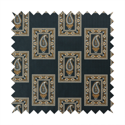 Fabric featuring a traditional repeating pattern of detailed white and gold paisley motifs, each enclosed within an ornate rectangular border on a charcoal black background.