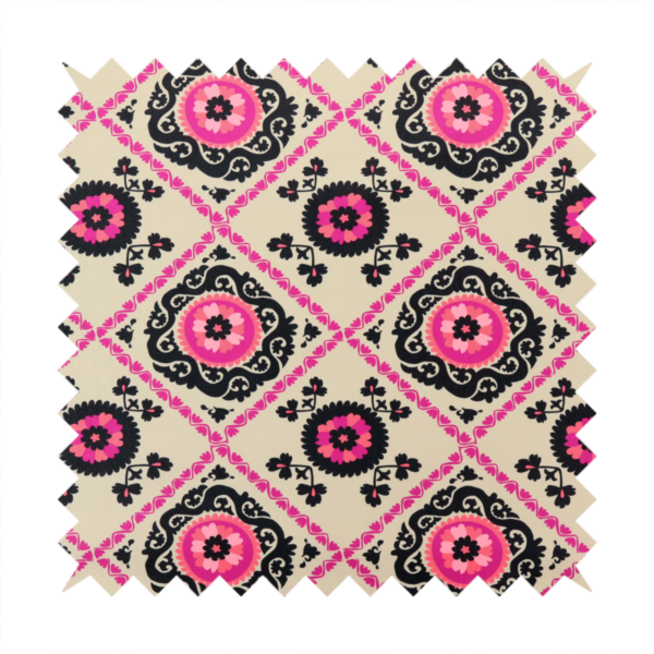 Fabric featuring a vibrant bohemian Suzani-style pattern with bold hot pink and black floral medallions arranged in a diamond lattice on a cream background.