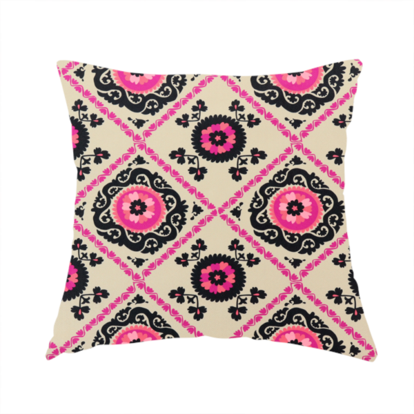 The fabric used to create this handmade cushion is a featuring a vibrant bohemian Suzani-style pattern with bold hot pink and black floral medallions arranged in a diamond lattice on a cream background.