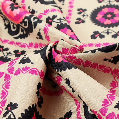 Fabric featuring a vibrant bohemian Suzani-style pattern with bold hot pink and black floral medallions arranged in a diamond lattice on a cream background.