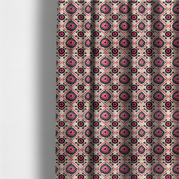 The fabric used to create these made-to-measure curtains is a featuring a vibrant bohemian Suzani-style pattern with bold hot pink and black floral medallions arranged in a diamond lattice on a cream background.