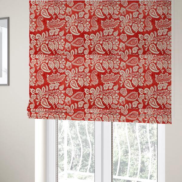The fabric used to create these Roman blinds is a featuring an ornate repeating pattern of elegant ivory paisley motifs and botanical flourishes over a textured, mottled crimson red background.