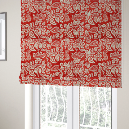 The fabric used to create these Roman blinds is a featuring an ornate repeating pattern of elegant ivory paisley motifs and botanical flourishes over a textured, mottled crimson red background.