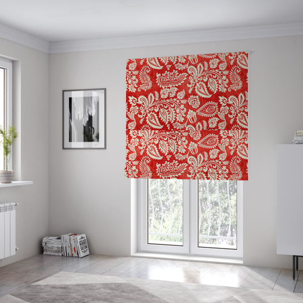 The fabric used to create these Roman blinds is a featuring an ornate repeating pattern of elegant ivory paisley motifs and botanical flourishes over a textured, mottled crimson red background.