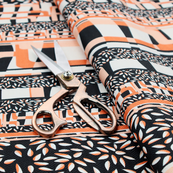 Fabric featuring a bold, multi-patterned horizontal striped design with alternating bands of geometric coral and cream blocks and dense black-and-white micro leaf speckles.