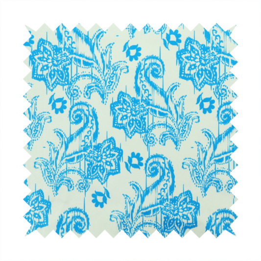 A bohemian-style textile featuring a bold ikat paisley pattern printed against a crisp off-white backdrop. The repeating motif showcases large, ornate teardrop paisley swirls integrated with stylized damask flowers.