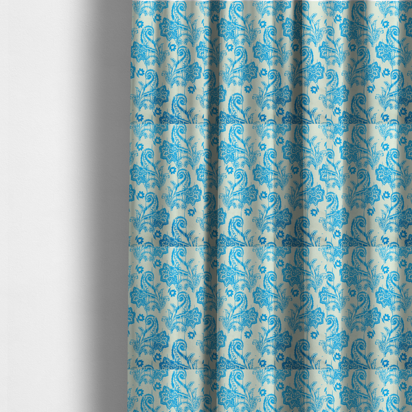 The fabric used to create these made-to-measure curtains is a bohemian-style textile featuring a bold ikat paisley pattern printed against a crisp off-white backdrop. The repeating motif showcases large, ornate teardrop paisley swirls integrated with stylized damask flowers.