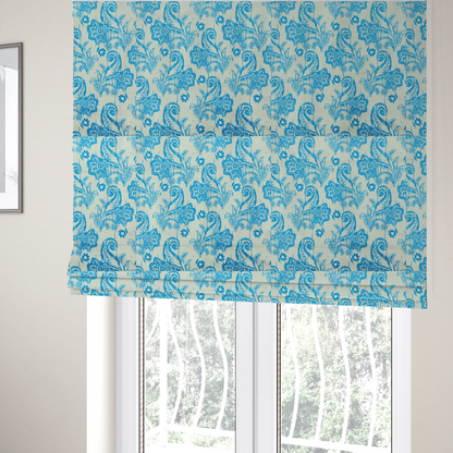 The fabric used to create these Roman blinds is a bohemian-style textile featuring a bold ikat paisley pattern printed against a crisp off-white backdrop. The repeating motif showcases large, ornate teardrop paisley swirls integrated with stylized damask flowers.
