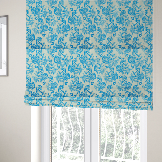 The fabric used to create these Roman blinds is a bohemian-style textile featuring a bold ikat paisley pattern printed against a crisp off-white backdrop. The repeating motif showcases large, ornate teardrop paisley swirls integrated with stylized damask flowers.