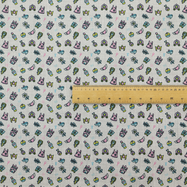 Fabric featuring a whimsical, miniature repeating pattern of pastel princess-themed doodles—including castles, carriages, and crowns—on a light grey linen-textured background.