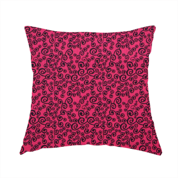 The fabric used to create this handmade cushion is a featuring a dense, repeating abstract pattern of intricate black swirls, scrolls, and curly tendrils tightly packed across a vibrant magenta pink background.