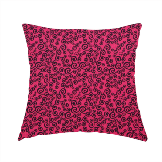 The fabric used to create this handmade cushion is a featuring a dense, repeating abstract pattern of intricate black swirls, scrolls, and curly tendrils tightly packed across a vibrant magenta pink background.