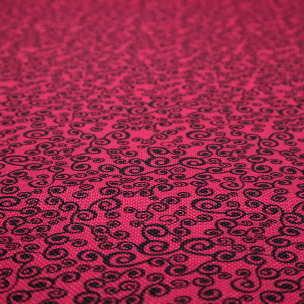 Fabric featuring a dense, repeating abstract pattern of intricate black swirls, scrolls, and curly tendrils tightly packed across a vibrant magenta pink background.