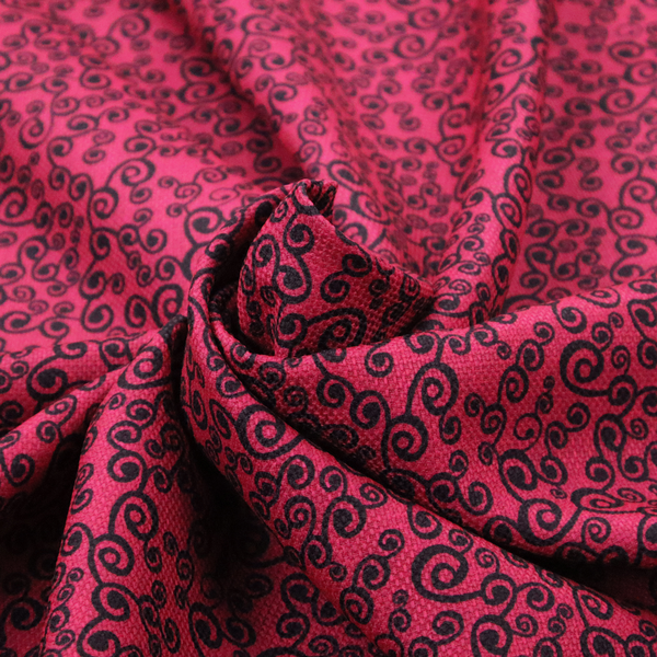 Fabric featuring a dense, repeating abstract pattern of intricate black swirls, scrolls, and curly tendrils tightly packed across a vibrant magenta pink background.