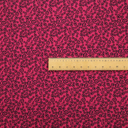 Fabric featuring a dense, repeating abstract pattern of intricate black swirls, scrolls, and curly tendrils tightly packed across a vibrant magenta pink background.