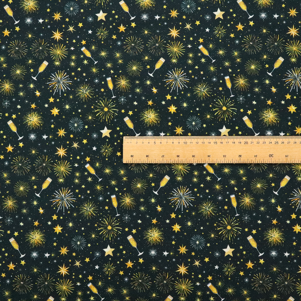 Fabric featuring a festive celebration print with an all-over micro pattern of golden champagne glasses, bursting fireworks, and twinkling stars on a deep black background.