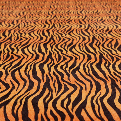 Fabric featuring a dense, repeating animal print pattern of vertical black tiger stripes over a vibrant orange background.