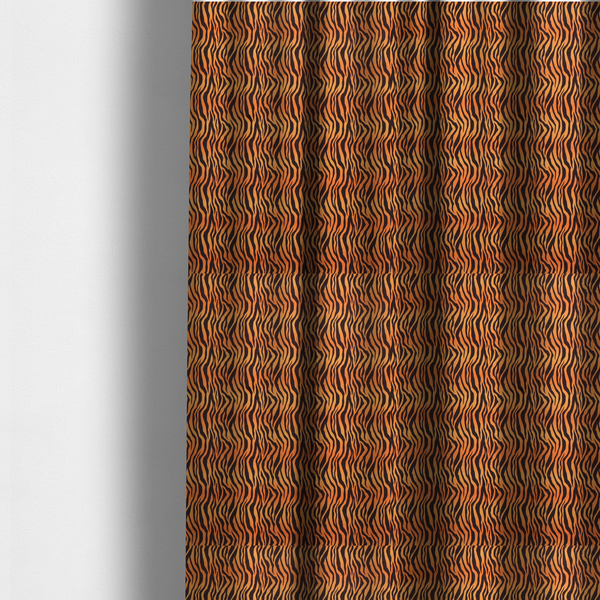 The fabric used to create these made-to-measure curtains is a featuring a dense, repeating animal print pattern of vertical black tiger stripes over a vibrant orange background.