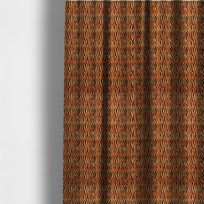 The fabric used to create these made-to-measure curtains is a featuring a dense, repeating animal print pattern of vertical black tiger stripes over a vibrant orange background.