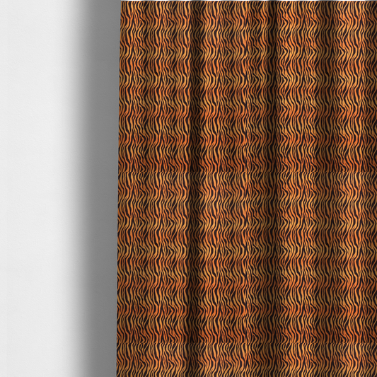 The fabric used to create these made-to-measure curtains is a featuring a dense, repeating animal print pattern of vertical black tiger stripes over a vibrant orange background.