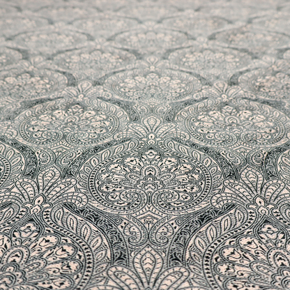 An intricate, repeating damask and paisley design on fabric, featuring elegant, symmetrical motifs.