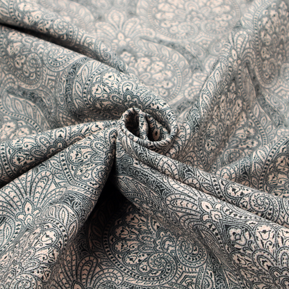 An intricate, repeating damask and paisley design on fabric, featuring elegant, symmetrical motifs.