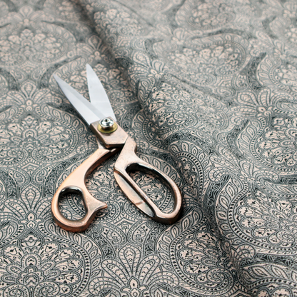 An intricate, repeating damask and paisley design on fabric, featuring elegant, symmetrical motifs.