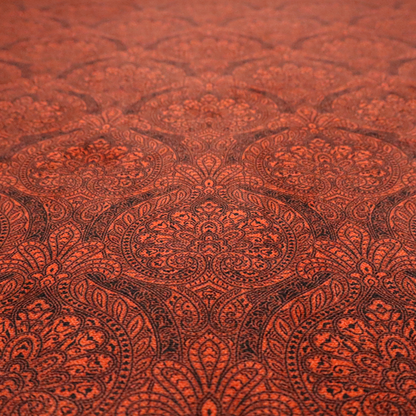 An intricate, repeating damask and paisley design on fabric, featuring elegant, symmetrical motifs.