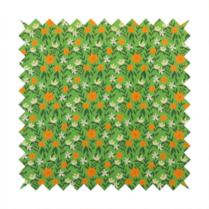 A bright green fabric featuring a dense, repeating pattern of small orange flowers, delicate white blossoms, and dark green leaves.