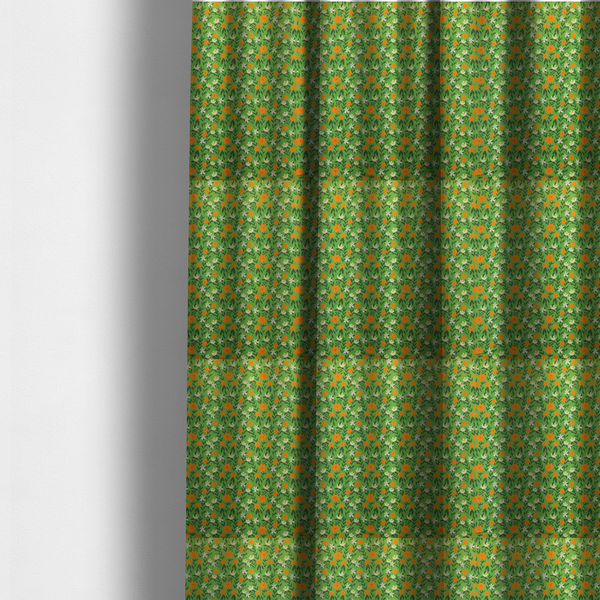 The fabric used to create these made-to-measure curtains is a bright green fabric featuring a dense, repeating pattern of small orange flowers, delicate white blossoms, and dark green leaves.