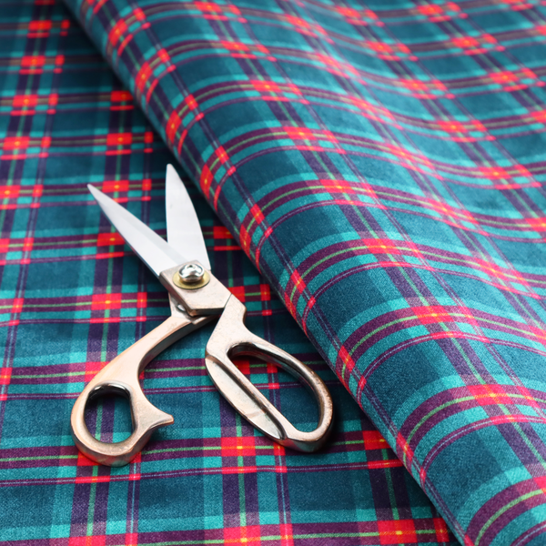 Vibrant teal and pink tartan plaid fabric featuring a classic checked pattern with intersecting lines in rich turquoise, bright magenta, and subtle yellow highlights.