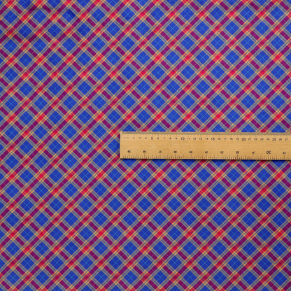 Vibrant blue and red diamond plaid fabric featuring an intricate diagonal checked pattern with intersecting lines in rich royal blue, bright red, and yellow highlights.