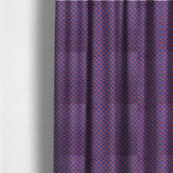 The fabric used to create these made-to-measure curtains is a vibrant blue and red diamond plaid fabric featuring an intricate diagonal checked pattern with intersecting lines in rich royal blue, bright red, and yellow highlights.