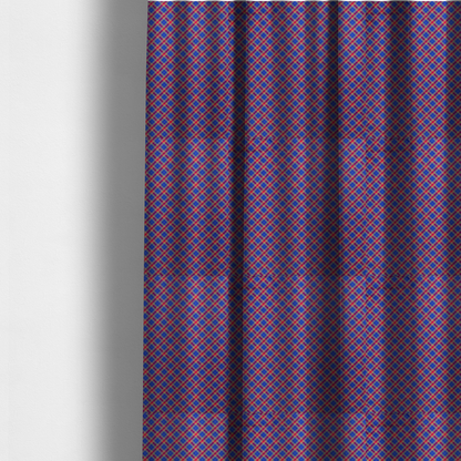 The fabric used to create these made-to-measure curtains is a vibrant blue and red diamond plaid fabric featuring an intricate diagonal checked pattern with intersecting lines in rich royal blue, bright red, and yellow highlights.
