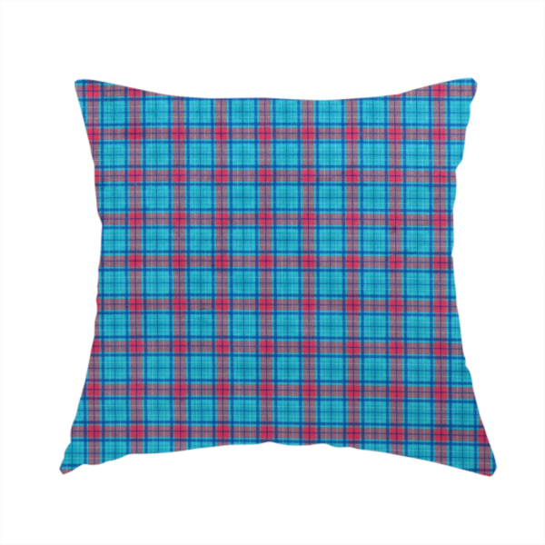 The fabric used to create this handmade cushion is a bright turquoise and red plaid fabric featuring a classic checked pattern with intersecting lines in rich turquoise, vibrant red, and dark blue accents.