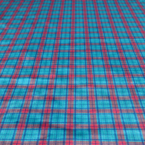 Bright turquoise and red plaid fabric featuring a classic checked pattern with intersecting lines in rich turquoise, vibrant red, and dark blue accents.