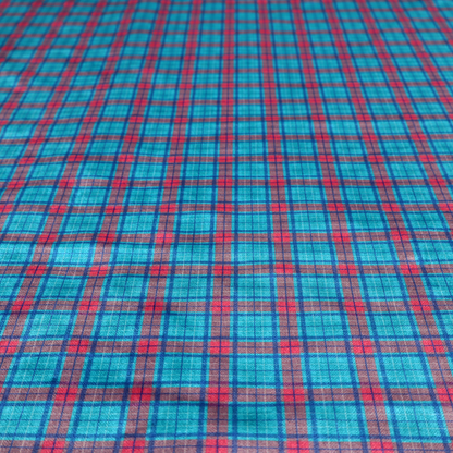 Bright turquoise and red plaid fabric featuring a classic checked pattern with intersecting lines in rich turquoise, vibrant red, and dark blue accents.