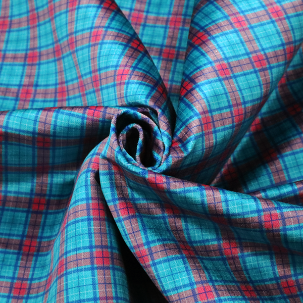 Bright turquoise and red plaid fabric featuring a classic checked pattern with intersecting lines in rich turquoise, vibrant red, and dark blue accents.