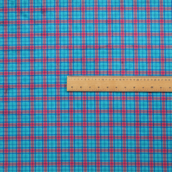 Bright turquoise and red plaid fabric featuring a classic checked pattern with intersecting lines in rich turquoise, vibrant red, and dark blue accents.