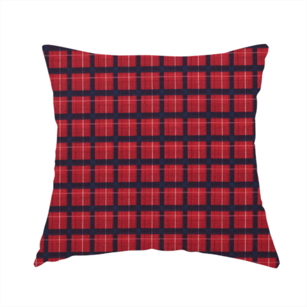 The fabric used to create this handmade cushion is a bold red and navy plaid fabric featuring a structured checked pattern with prominent dark navy grids, vibrant red blocks, and subtle white pin lines.