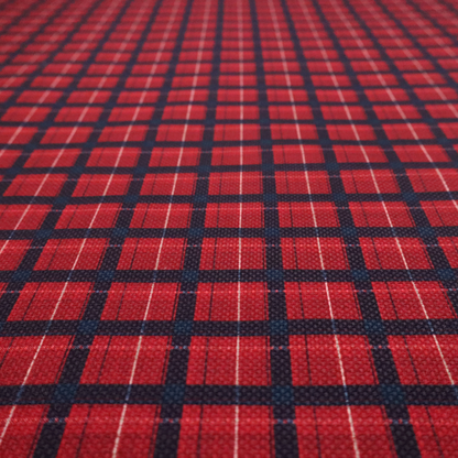 Bold red and navy plaid fabric featuring a structured checked pattern with prominent dark navy grids, vibrant red blocks, and subtle white pin lines.