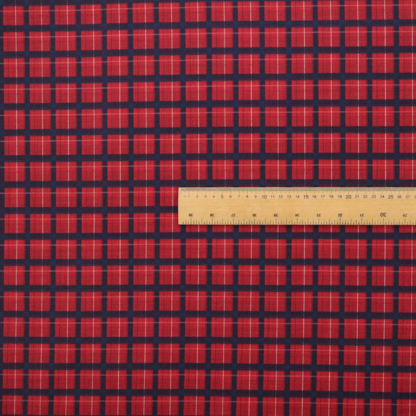 Bold red and navy plaid fabric featuring a structured checked pattern with prominent dark navy grids, vibrant red blocks, and subtle white pin lines.